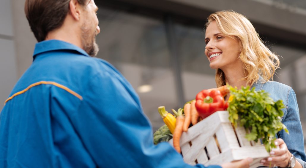 enthusiastic-sincere-woman-grateful-for-couriers-services-97076502-2
